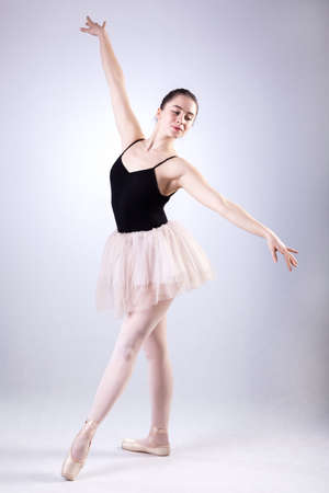 A posing ballet dancer wearing a tulle cream skirtの写真素材