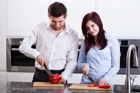 Young couple preparing meal in the kitchenの写真素材
