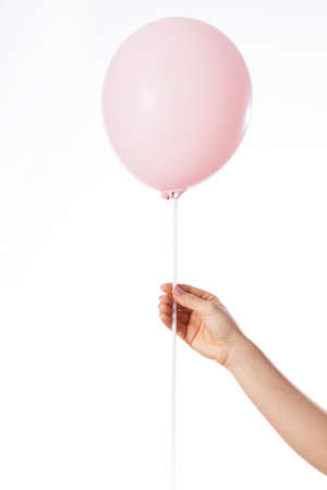Hand holding pink balloon with place to put your text hereの写真素材
