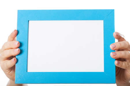 Woman's hands holding blue frame with empty place for your advert text
