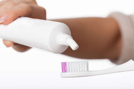 Person preparing to brushing teeth and applying a toothpaste on brush