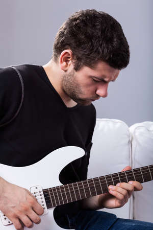 Rockman during playing electric guitar at home