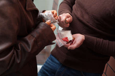 A drug dealer selling portions of heroine, hashish and tabs