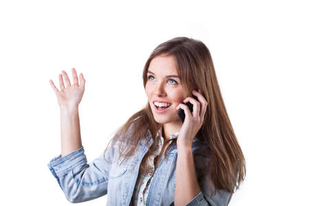 Pretty young girl talking vigorously with friend on the phone