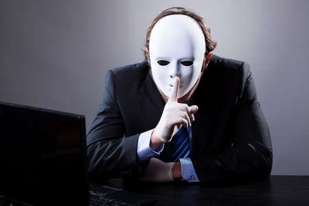 Portrait of man wearing elegant suit in white mask の写真素材