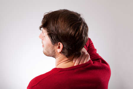 Young man suffering from neck pain, horizontal