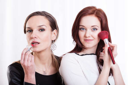 Pretty women making up before go outの写真素材