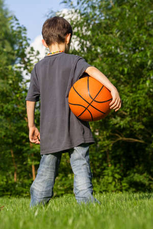 Little basketball player in the gardenの写真素材