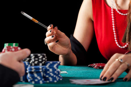 A closeup of a female casino gambles smoking a cigaretteの写真素材