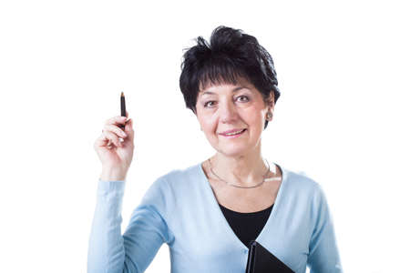 A smart middle-aged woman with a pen wearing elegant clothesの写真素材