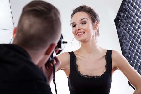 Model in black dress smiling for a photoの写真素材