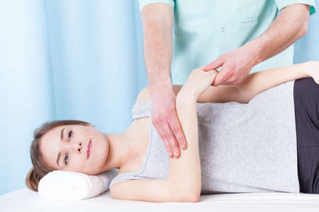 Young woman getting professional therapeutic arm massageの写真素材