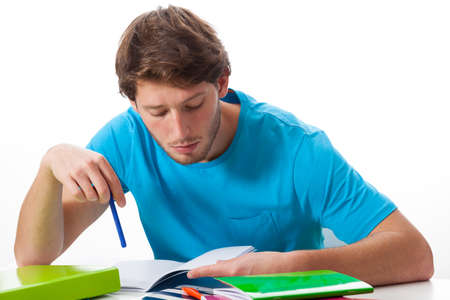 Male student working on task on isolated background