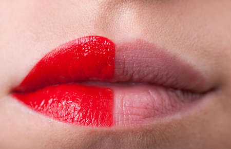 Full lips half covered in red lipstick