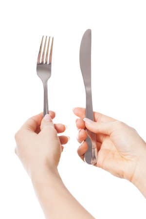 Woman's hands holding silver knife and forkの写真素材