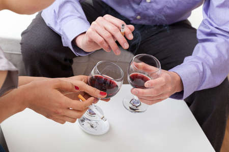 Man and woman addicted to alcohol and cigarette