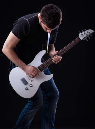 Guitarist from rockband during his solo on a stageの写真素材