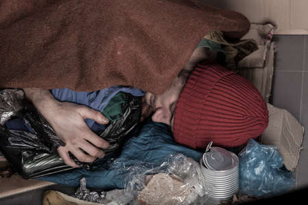 Horizontal view of a homeless sleeping on the streetの写真素材