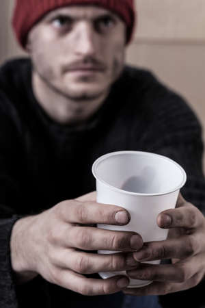 Vertical view of a man begging for moneyの写真素材
