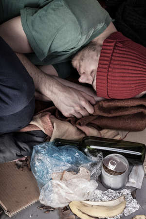 Homeless and alcoholic sleeping on the streetの写真素材