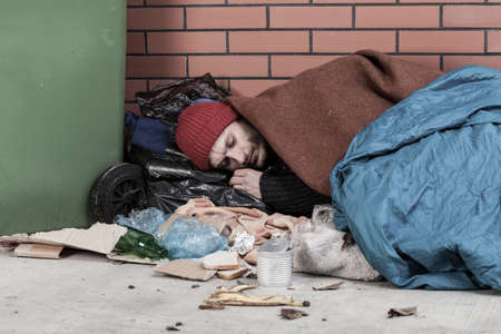 Poor man sleeping on the street, horizontalの写真素材