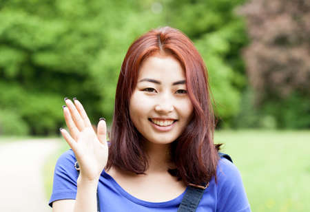 Smiling mongolian girl in a park, horizontalの写真素材