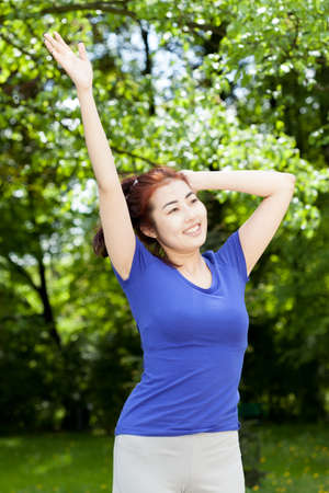 Happy woman after morning training in a parkの写真素材