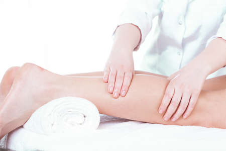 Lady having leg massage in spa