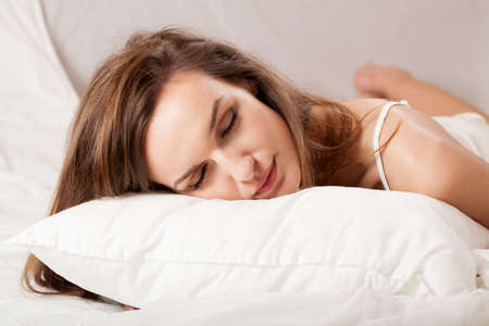 Horizontal view of attractive young woman sleeping in bed