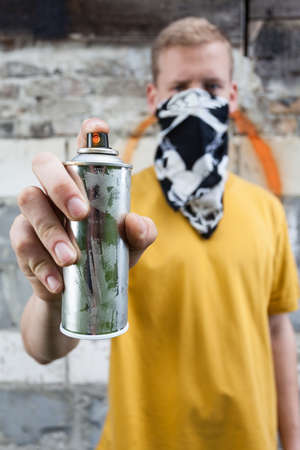 Vertical view of a boy after painting graffitiの写真素材