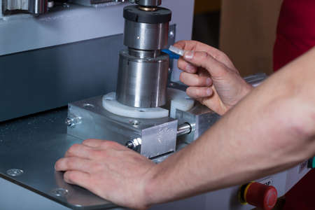 Close-up of machine operator hands during work at factory