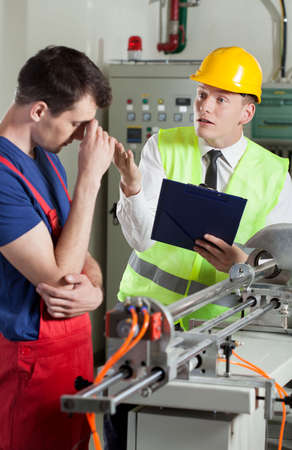 Supervisor yelling at worker in a factory