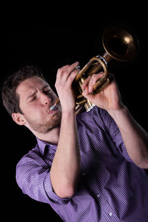 Close-up of a young man playing a trumpet
