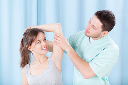 Physiotherapist and his young, female patient, horizontal