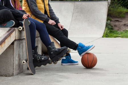 Youth people spends free time at a skatepark