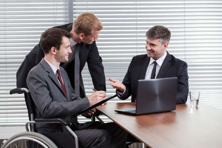 Happy disabled man during business meeting, horizontalの写真素材