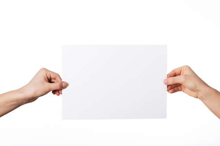 Hands holding blank sheet of paper on isolated backgroundの写真素材