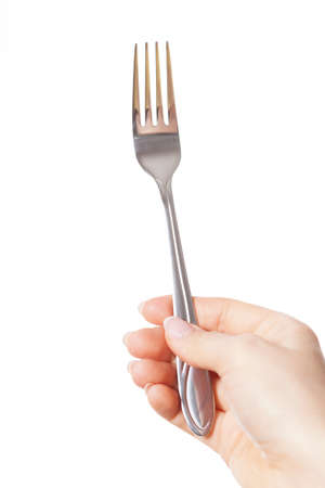Hand holding a silver fork on isolated backgroundの写真素材