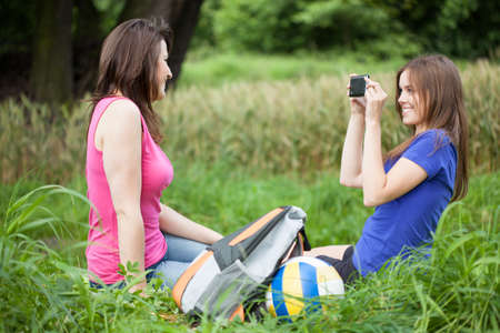 Friends take a photo on a gladeの写真素材