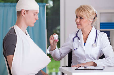 Doctor giving drugs to patient after accidentの写真素材