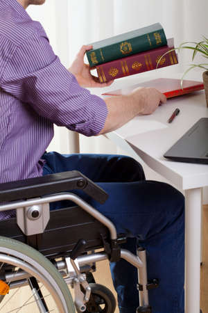 A disabled man sitting at a desk and learnsの写真素材
