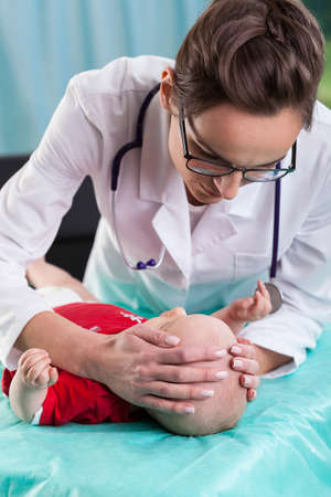 Close-up of female doctor examining little baby boyの写真素材