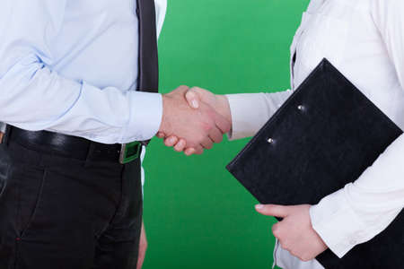Handshake before business meeting, isolated on greenの写真素材