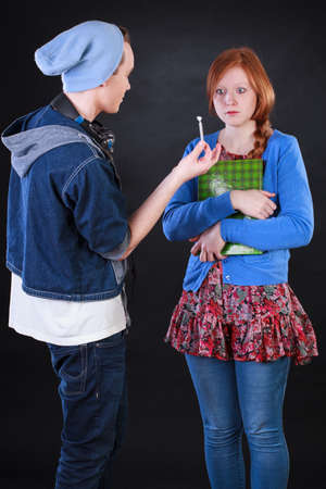 Teenager boy giving marijuana to polite friendの写真素材