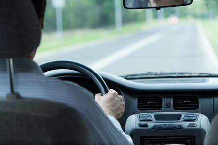 Horizontal view of man during driving carの写真素材