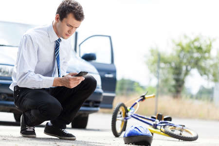 Man calling for help after accident on the streetの写真素材