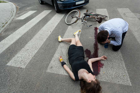 Woman killed by car on the streetの写真素材