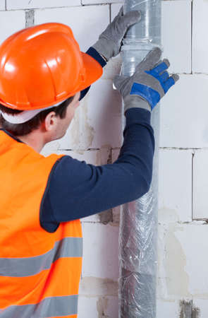 Close-up of a plumber working at construction siteの写真素材