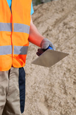 Close-up of a hand of manual worker with grout floatの写真素材