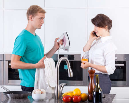 Busy wife has too little time to ironingの写真素材